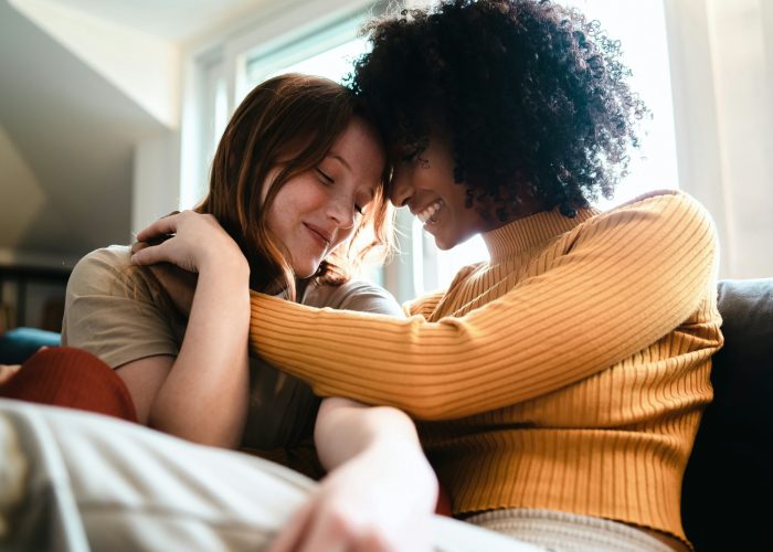 Lesbian women caressing on the couch